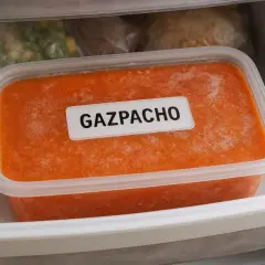Recipiente con gazpacho congelado en el congelador. ¡Así se puede congelar el gazpacho para disfrutarlo más tarde!