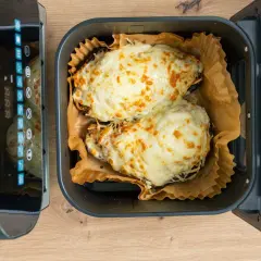 Dos berenjenas rellenas gratinadas con queso dorado, listas para disfrutar tras su paso por la airfryer.