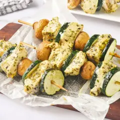 Brochetas de pollo marinadas con calabacín y champiñones, listas para asar.
