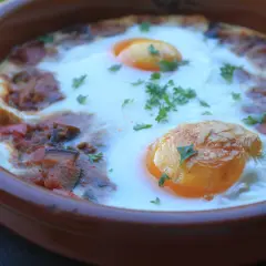 Un plato de samfaina con huevos escalfados, decorado con perejil fresco. ¡Una delicia para probar esta samfaina recepta!