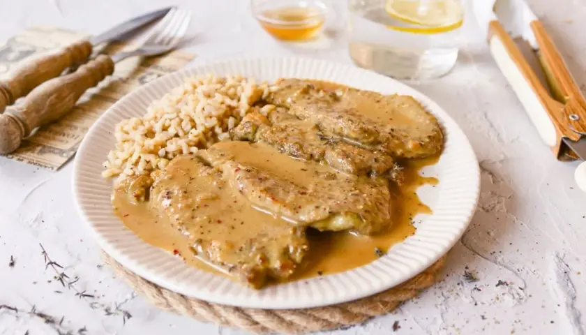 Escalopines de ternera en salsa cremosa con arroz. Un plato delicioso y reconfortante.