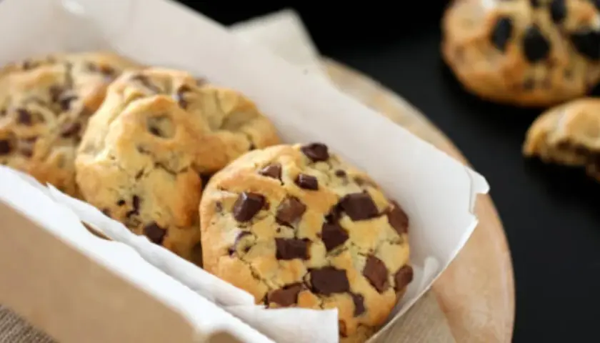 Caja de galletas de chocolate recién horneadas, con trozos generosos de chocolate oscuro. ¡Un placer irresistible!